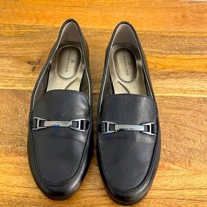 Black leather Bandolino loafers with metal clasp.